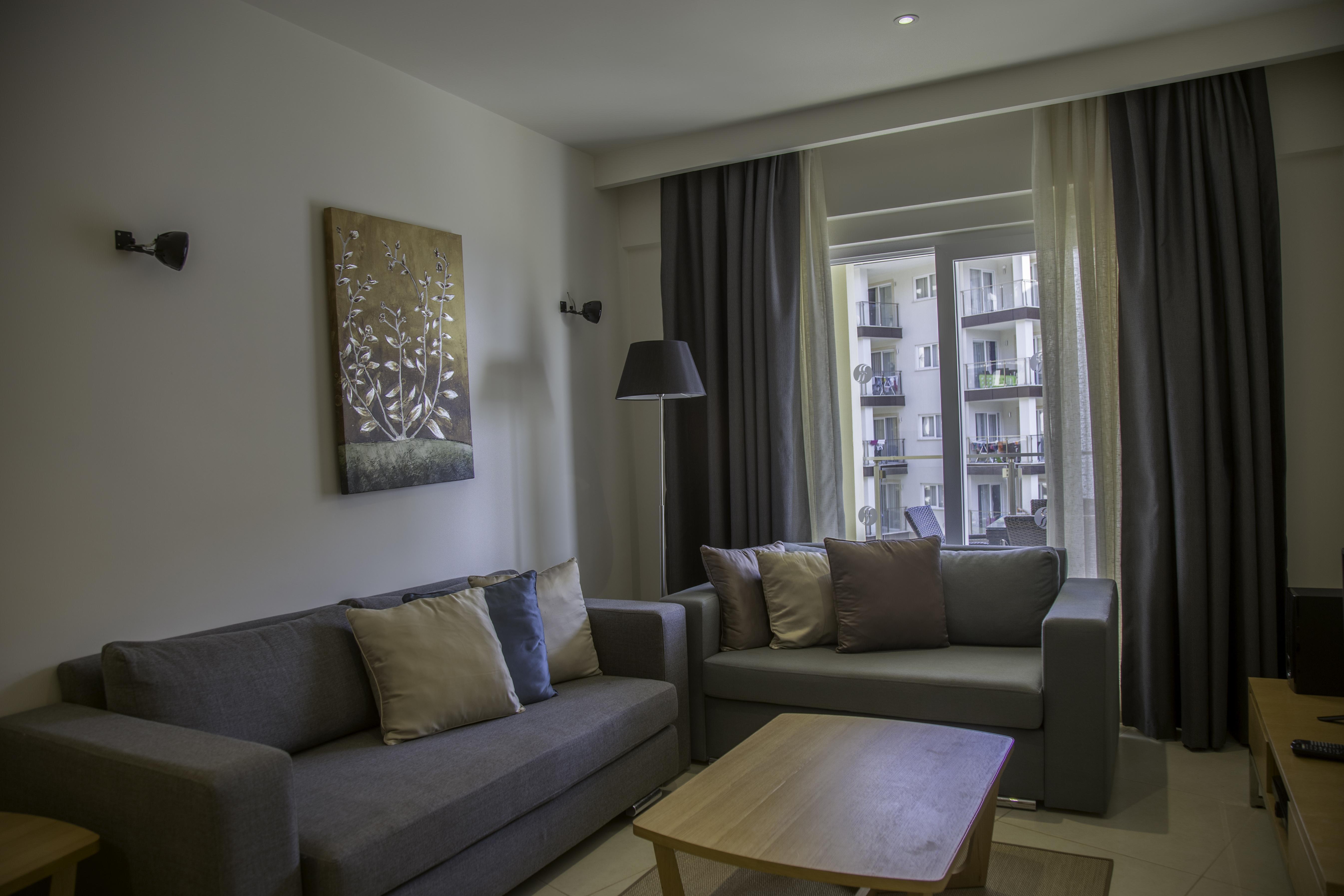 Ramada Resort Kusadasi & Golf Eksteriør bilde A living room in a serviced apartment in Bucharest, Romania